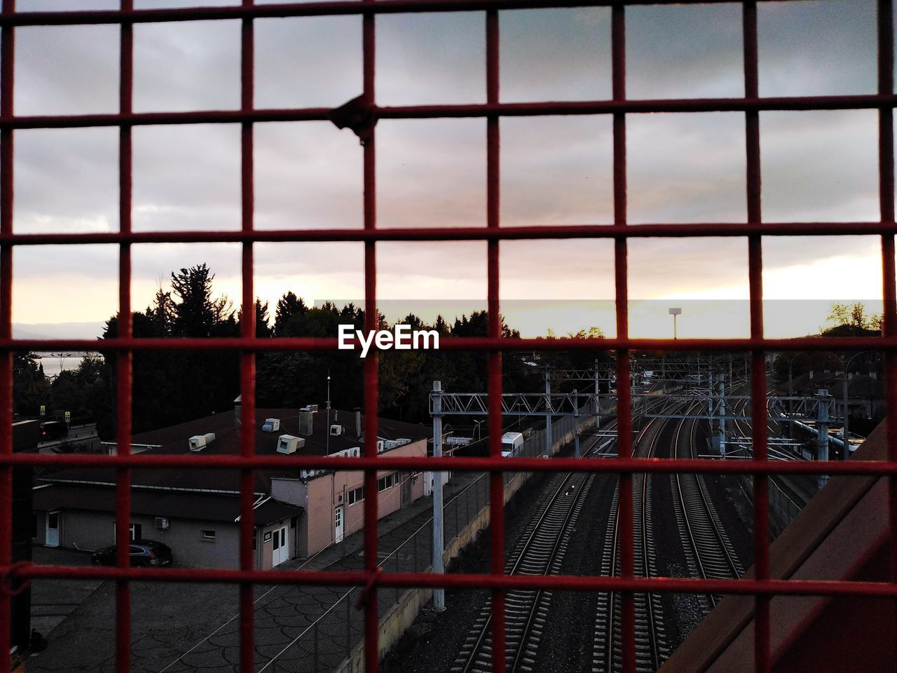 FENCE AGAINST SKY AT SUNSET