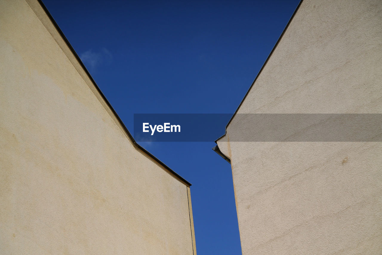 Low angle view of buildings against blue sky