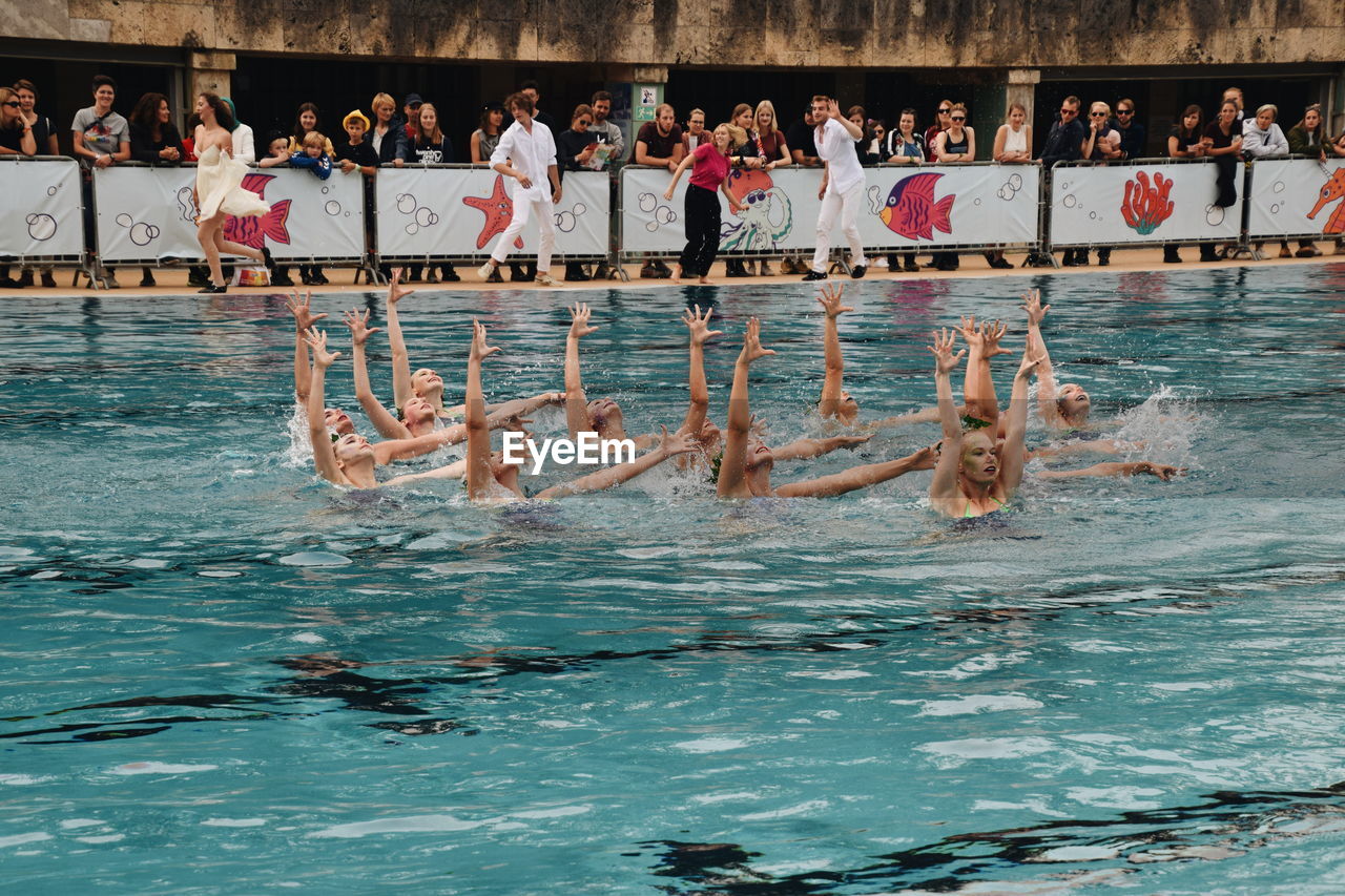 PEOPLE SWIMMING IN POOL