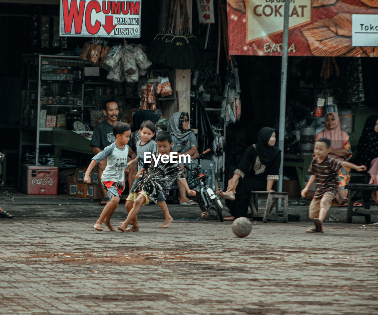 Boy playing soccer with his partner