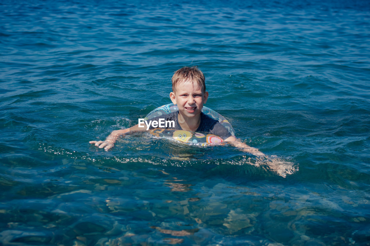 Portrait of smiling girl swimming in sea
