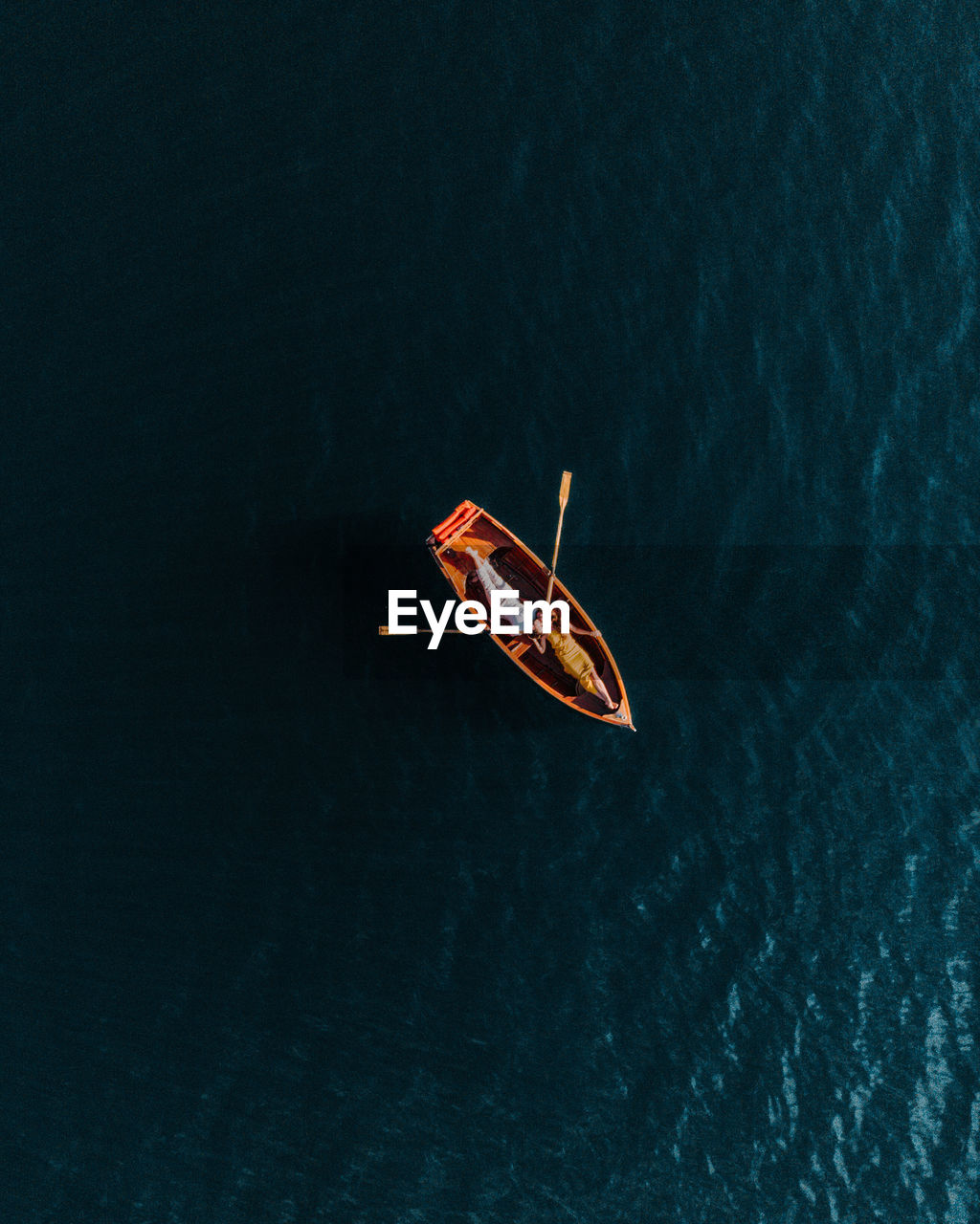 Directly above shot of couple kissing on boat in lake