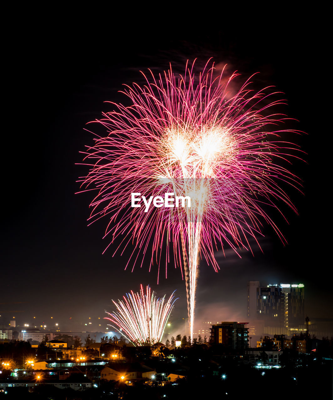 FIREWORK DISPLAY OVER ILLUMINATED CITY