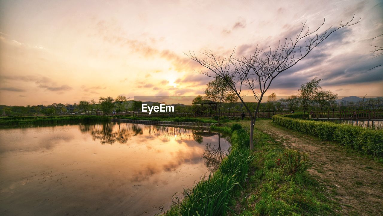 Scenic view of lake against sky during sunset