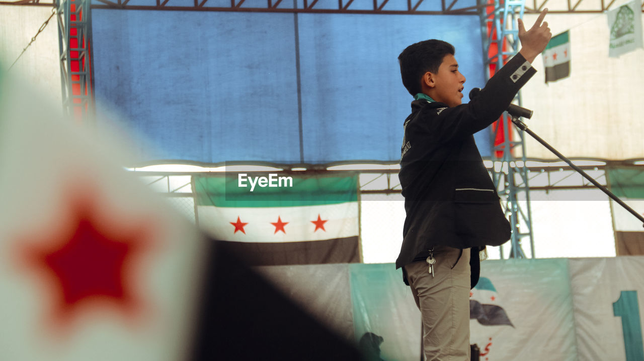 Boy giving speech on stage