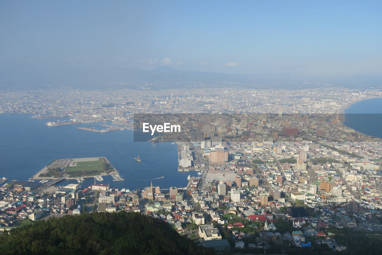 High angle view of city buildings against sky