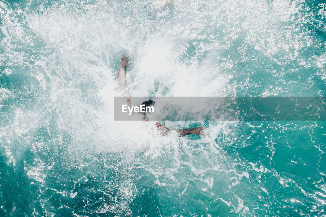 Directly above shot of man swimming into sea