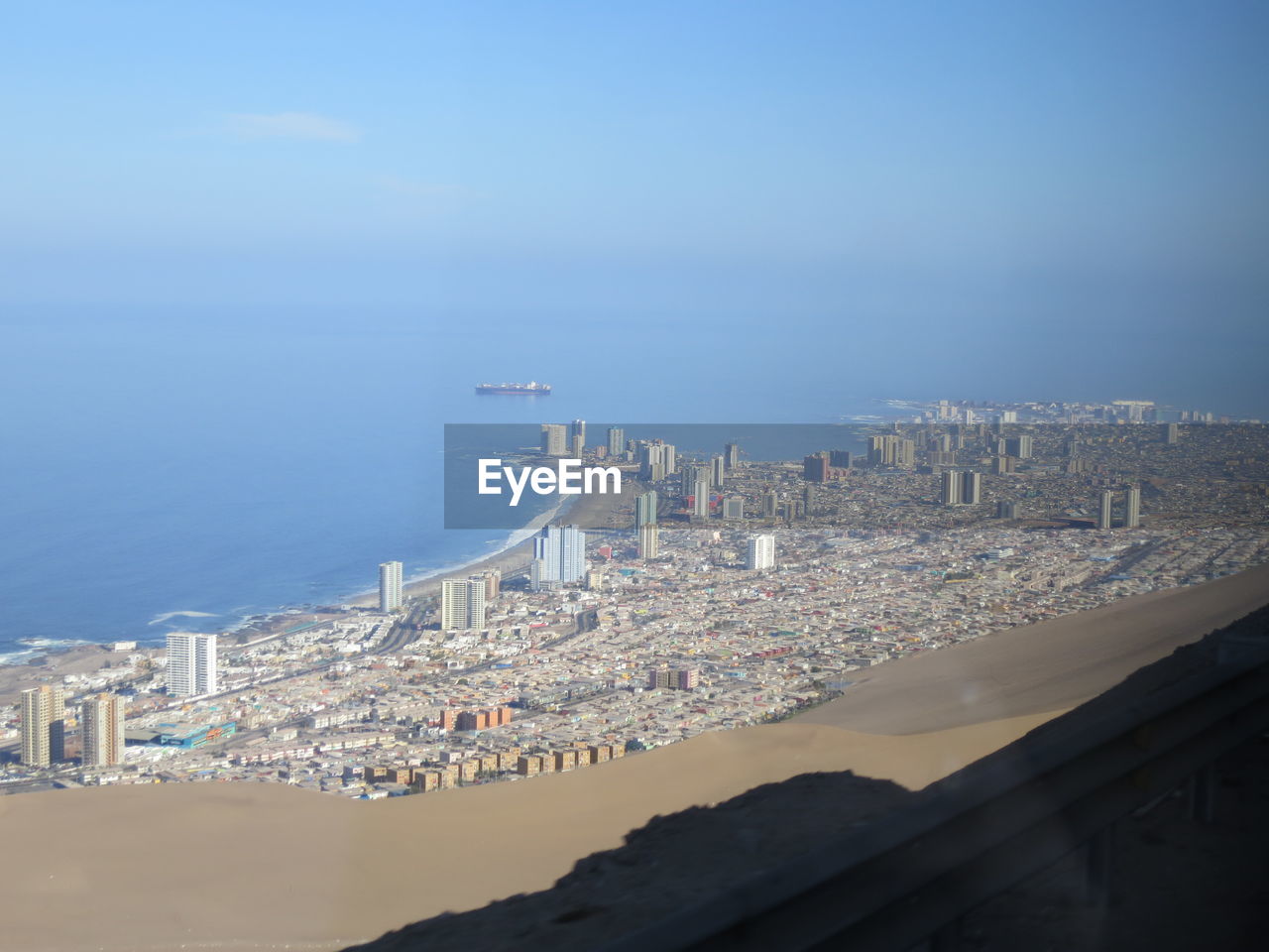 High angle view of buildings by sea against sky