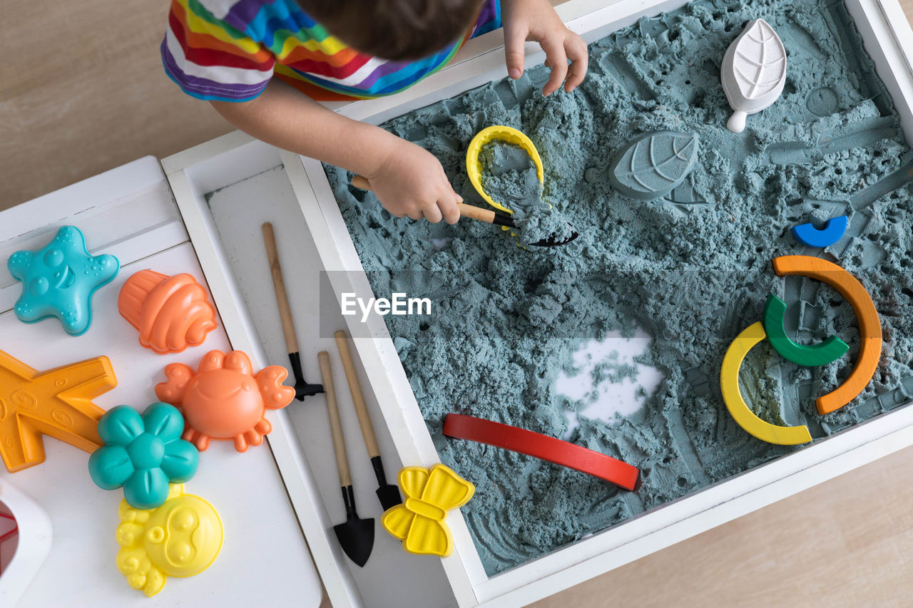 high angle view of girl playing with toy on table