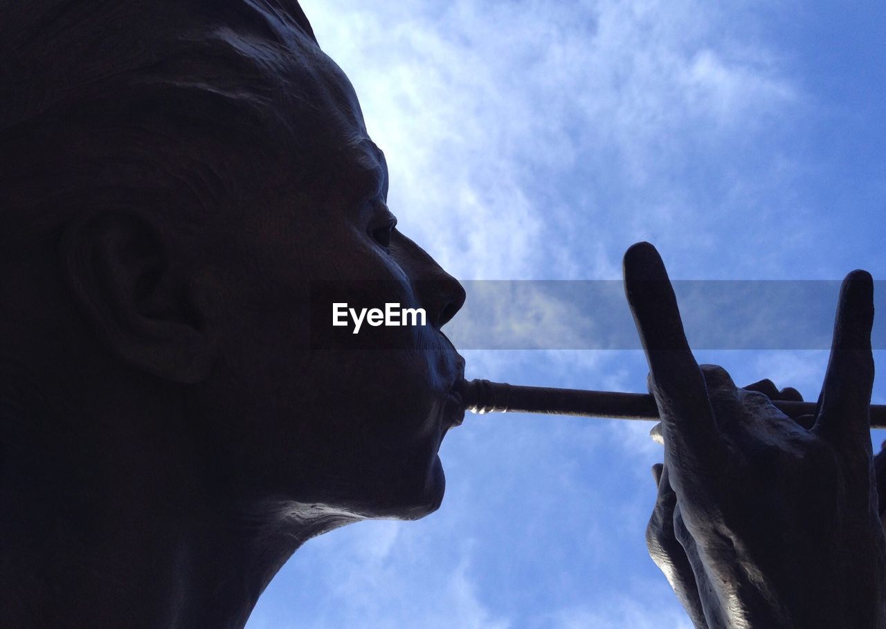 Close-up of statue against cloudy sky