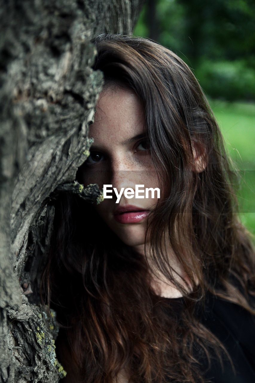 PORTRAIT OF A YOUNG WOMAN WITH TREE