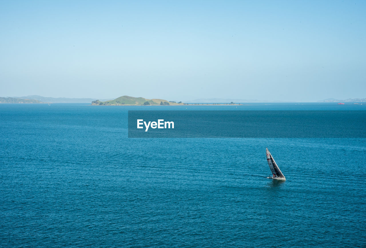 Scenic view of sailboat in sea against sky