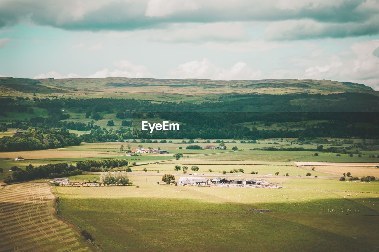 Scenic view of farm against sky