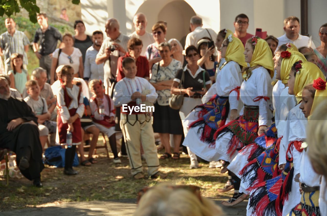 Women dancing on land by spectators