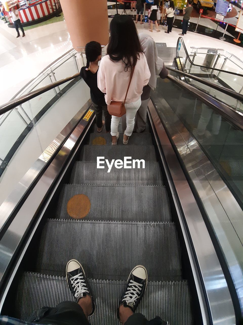 escalator, indoors, adult, architecture, men, one person, business, business finance and industry, lifestyles, women, footwear, clothing, technology, public transport, store, interior design, high angle view, person, standing, transport