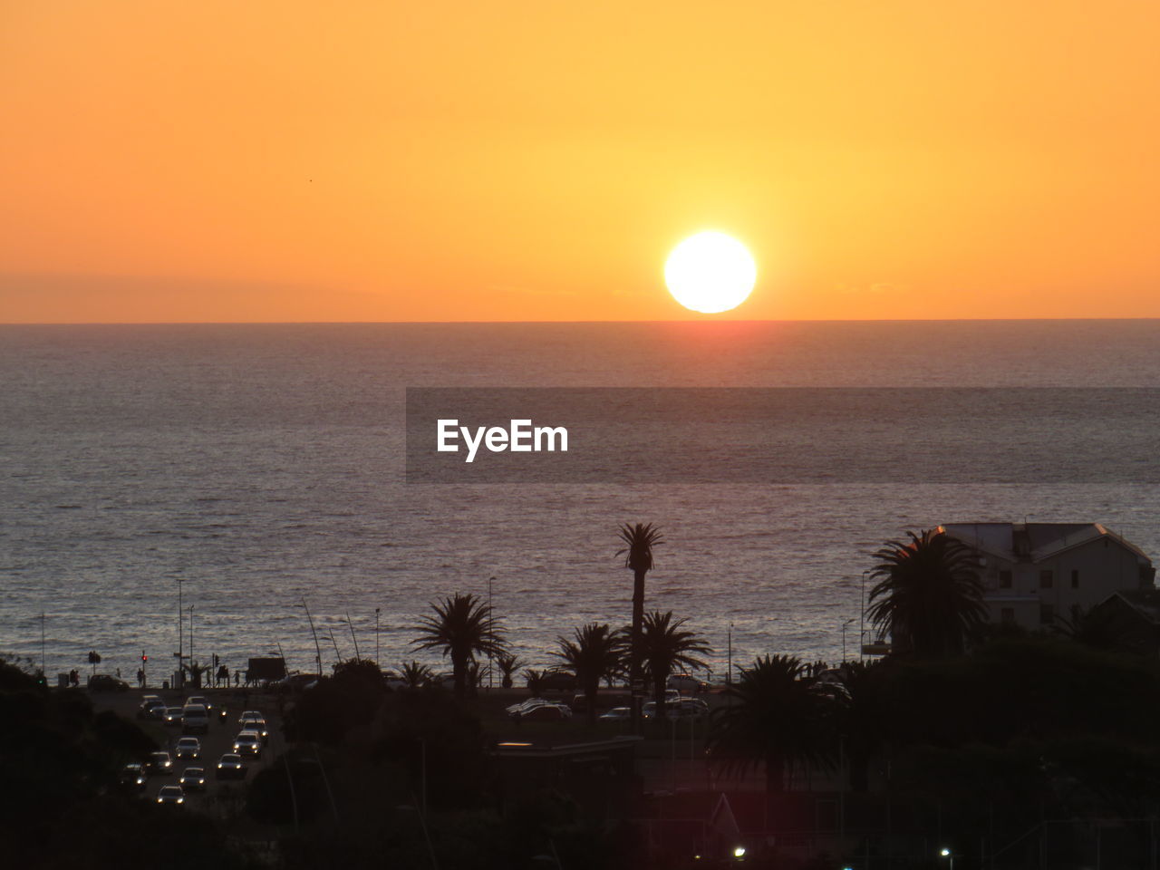 SCENIC VIEW OF SEA AGAINST ORANGE SKY