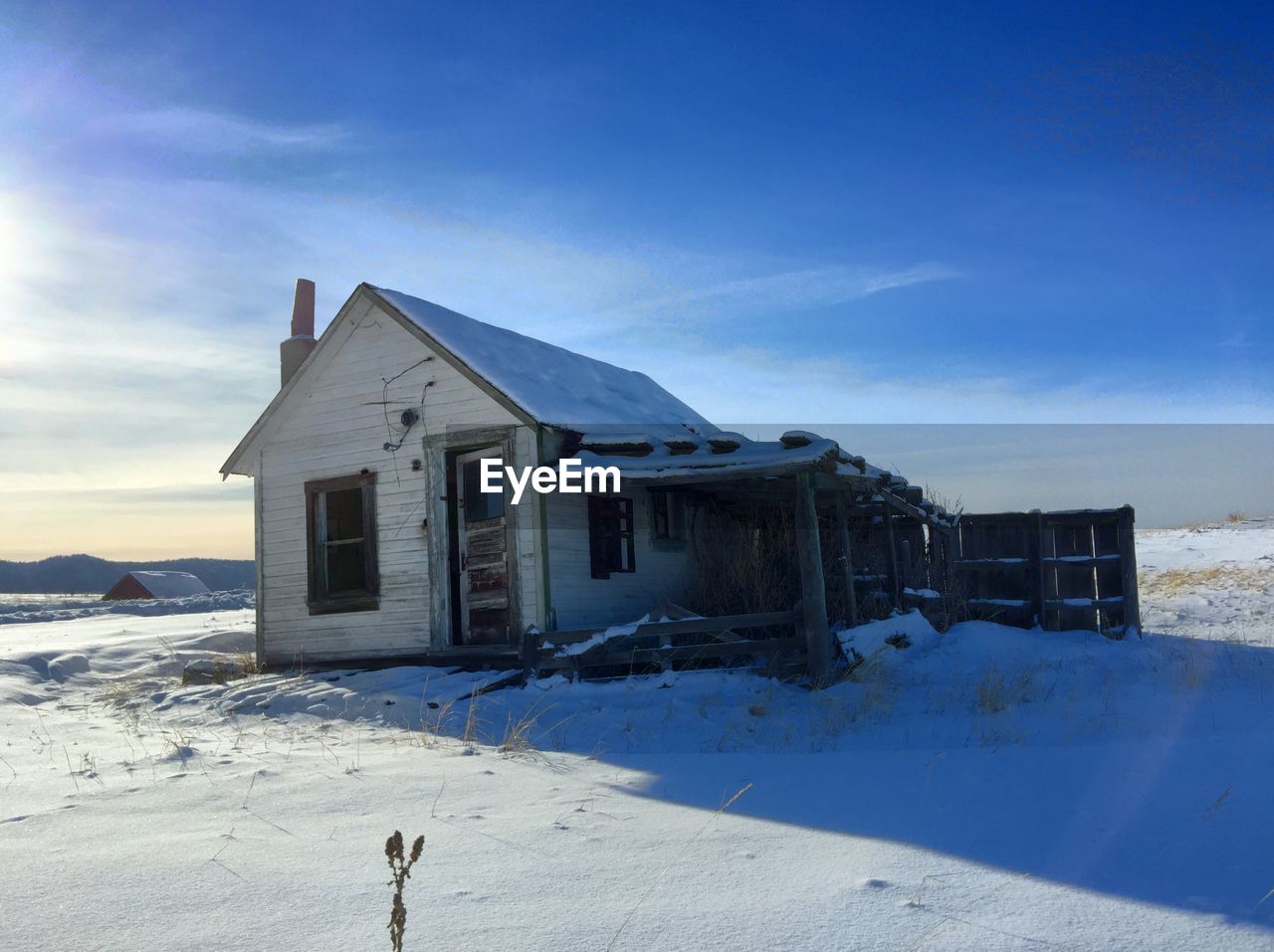 SNOW COVERED HOUSES AGAINST CLEAR SKY