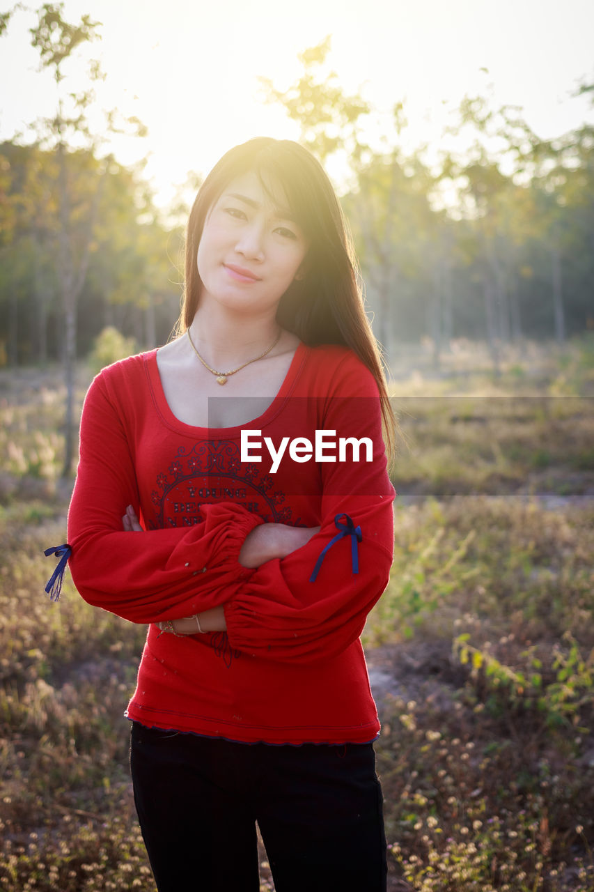 BEAUTIFUL YOUNG WOMAN STANDING IN A SUNLIGHT