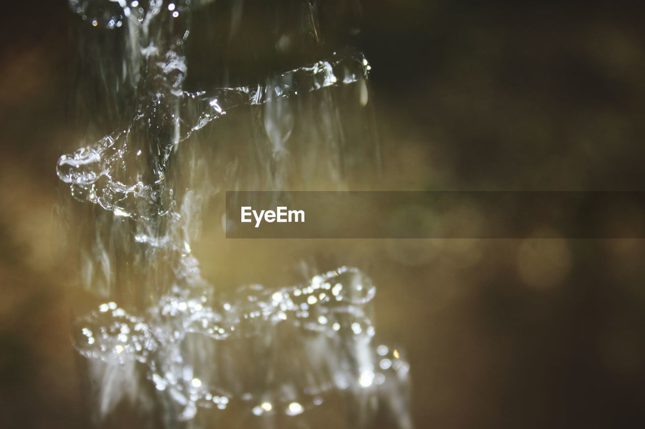 CLOSE-UP OF WATER SPLASHING IN ICE