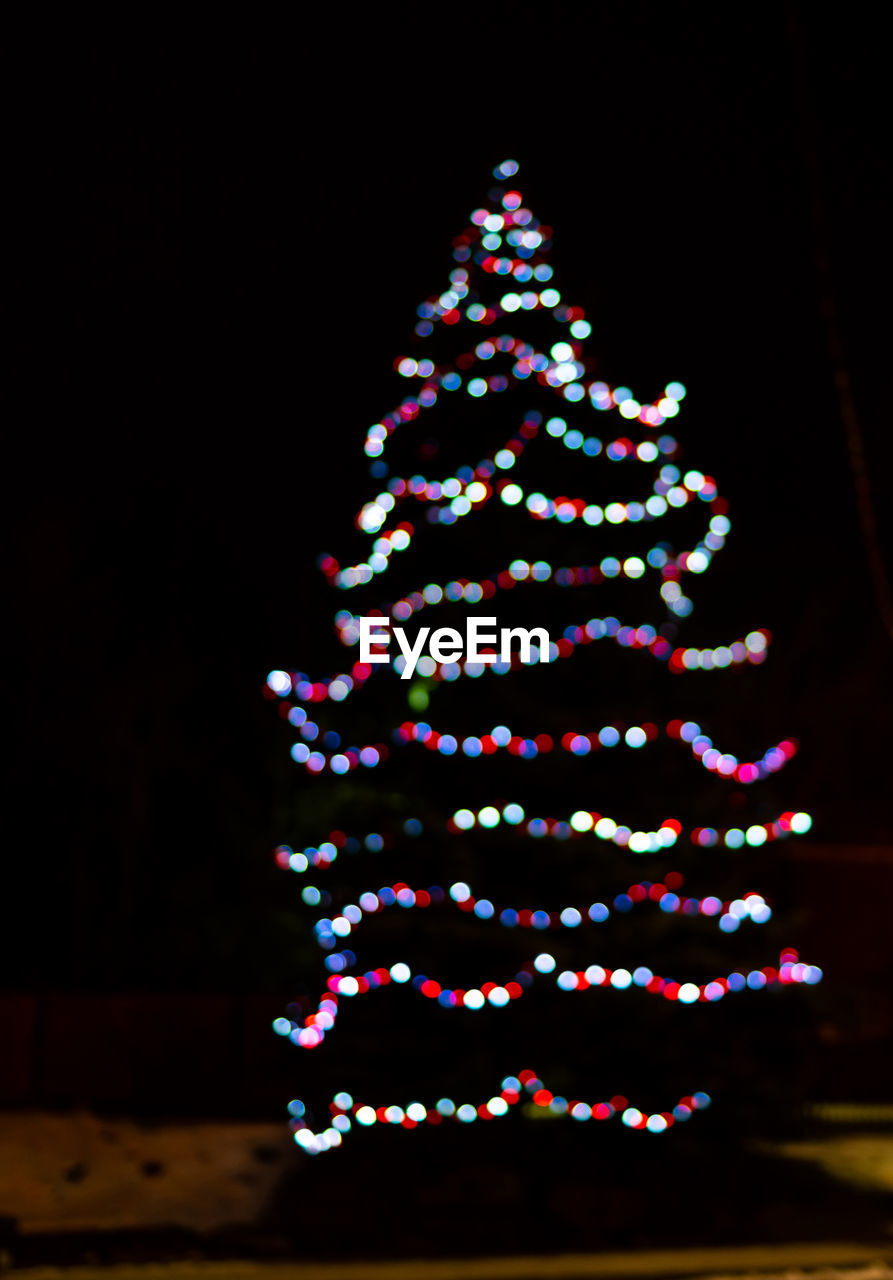 Illuminated christmas tree at night