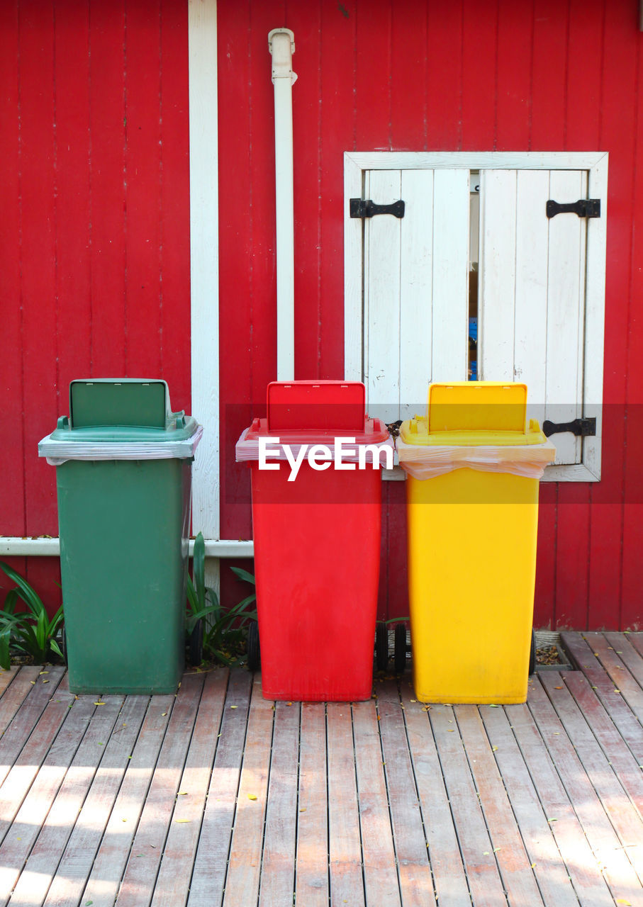 Colorful garbage cans by window