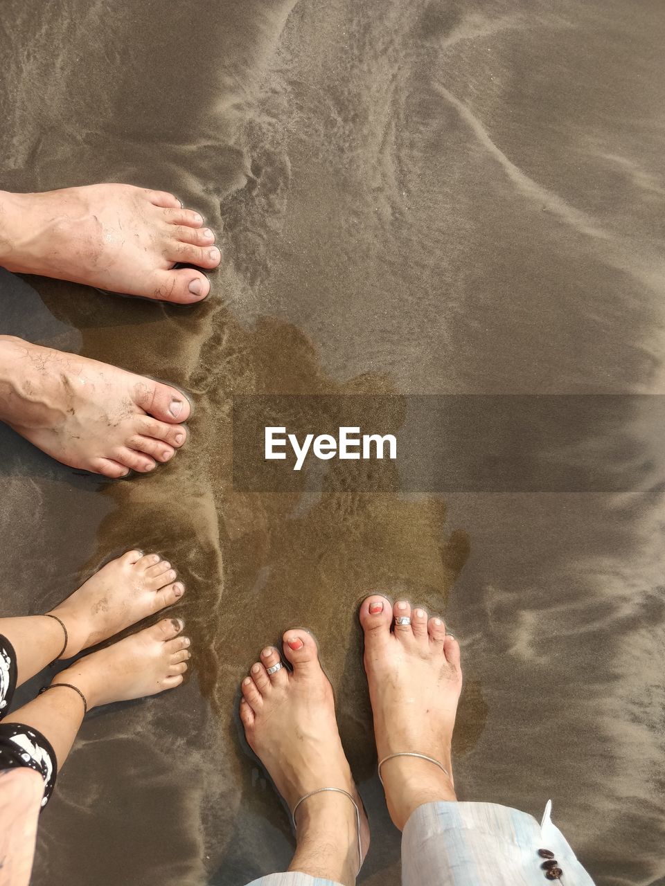 LOW SECTION OF MAN STANDING IN WATER