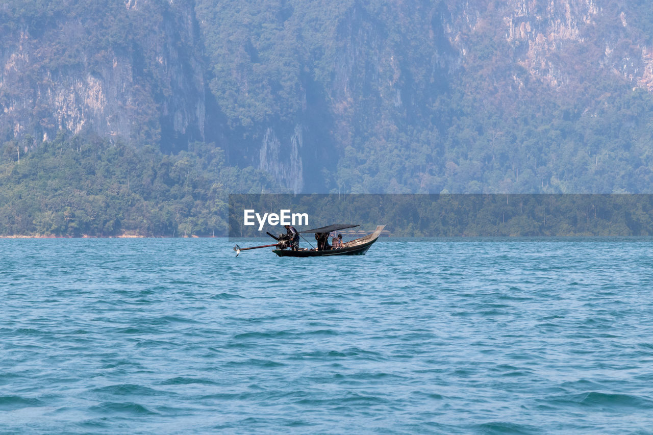 PEOPLE SAILING ON SEA