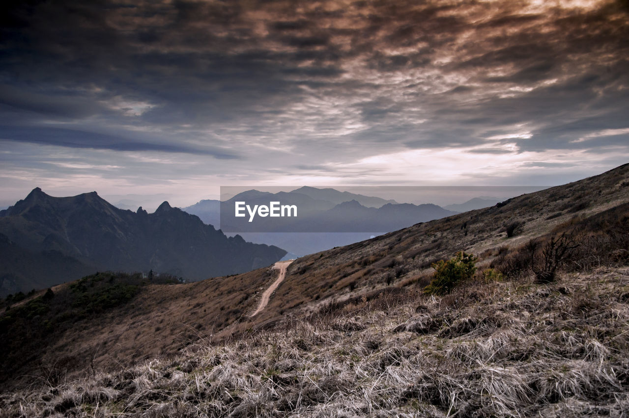 View of mountain range against cloudy sky