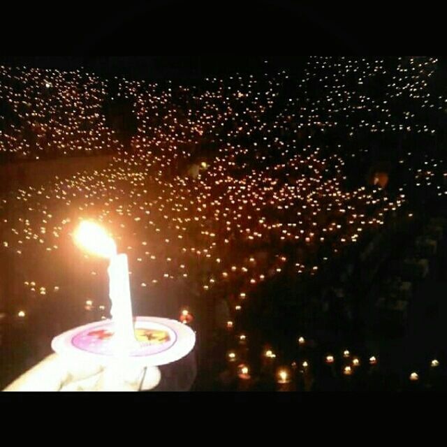 CLOSE-UP OF LIT CANDLES