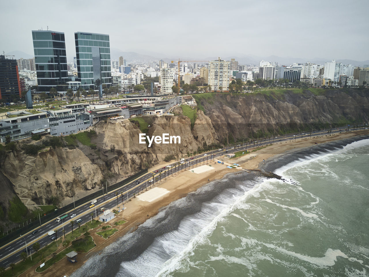 Aerial view of city by river against sky