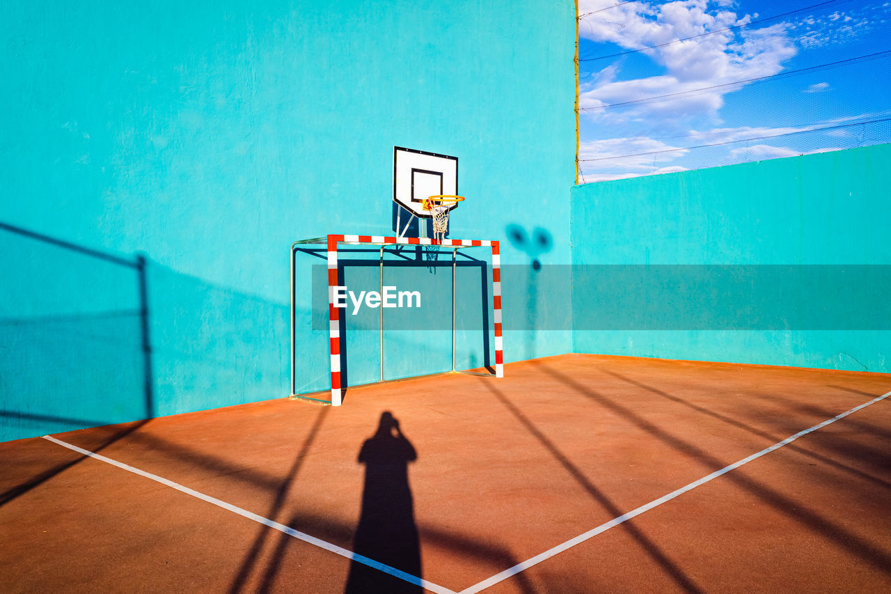 VIEW OF BASKETBALL COURT AGAINST BLUE SKY