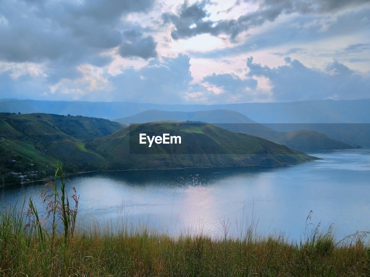 Scenic view of lake and mountains against sky