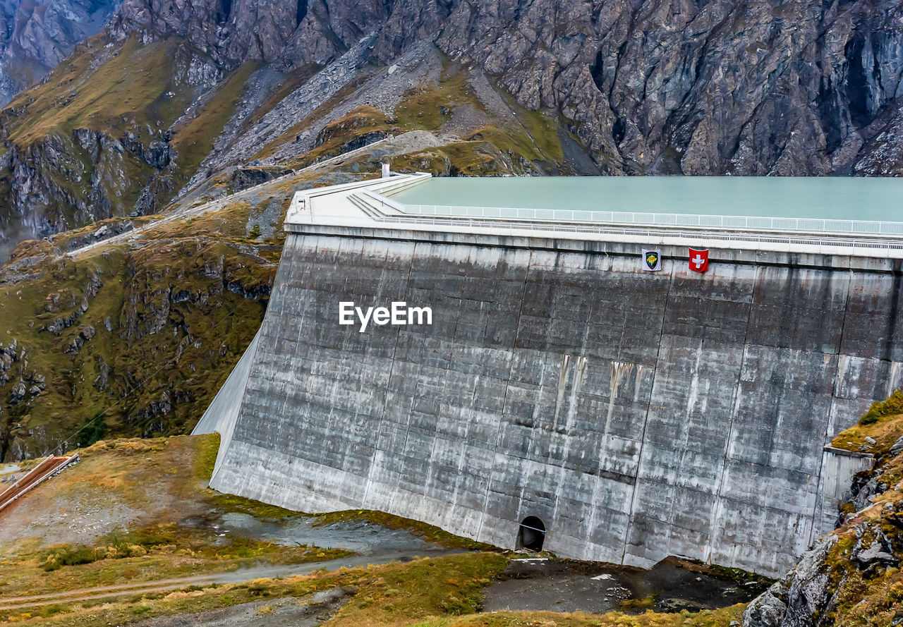 Grande dixence dam in swiss alps. the tallest gravity dam. high angle view of dam on mountain