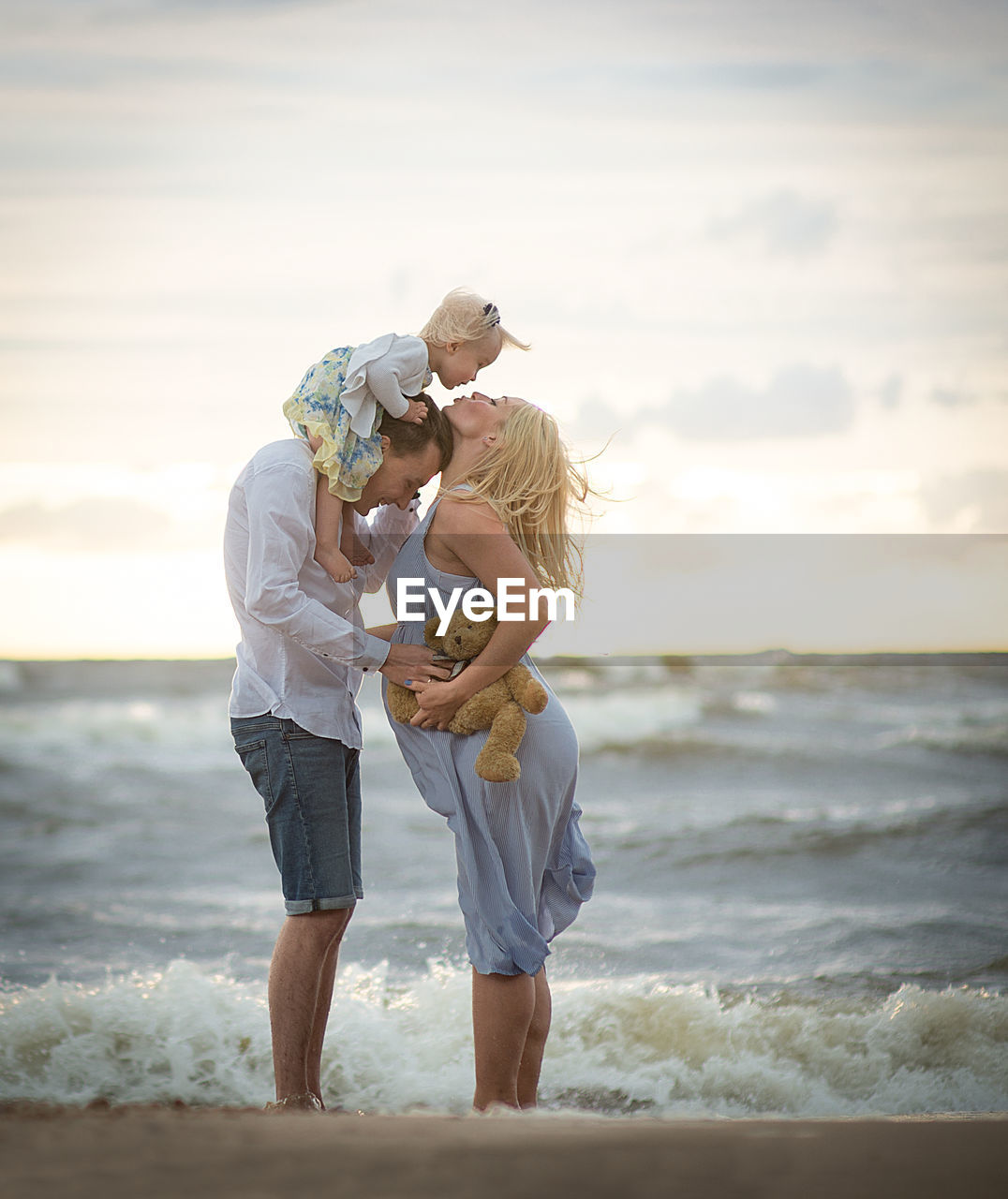 Parents with baby girl at beach