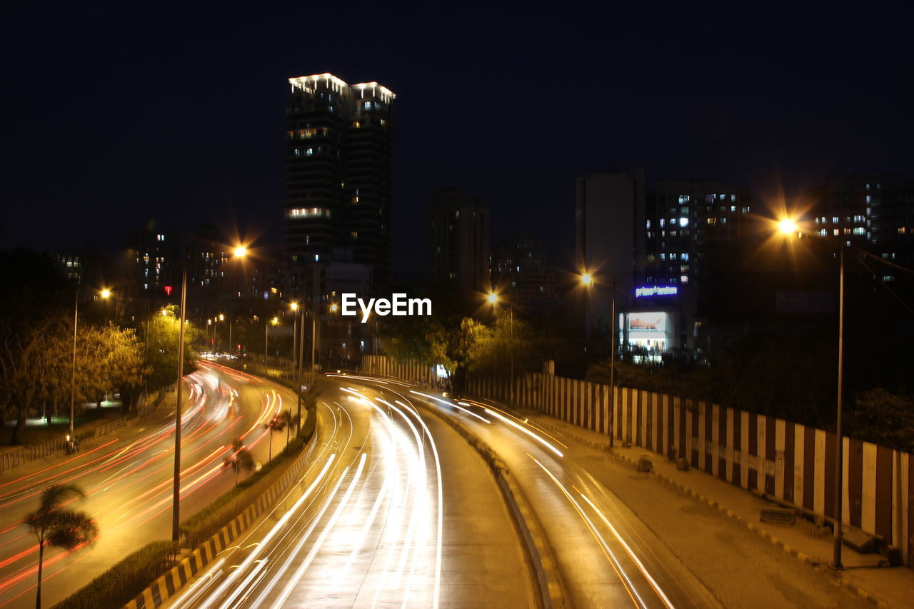 Light trails on road in city at night