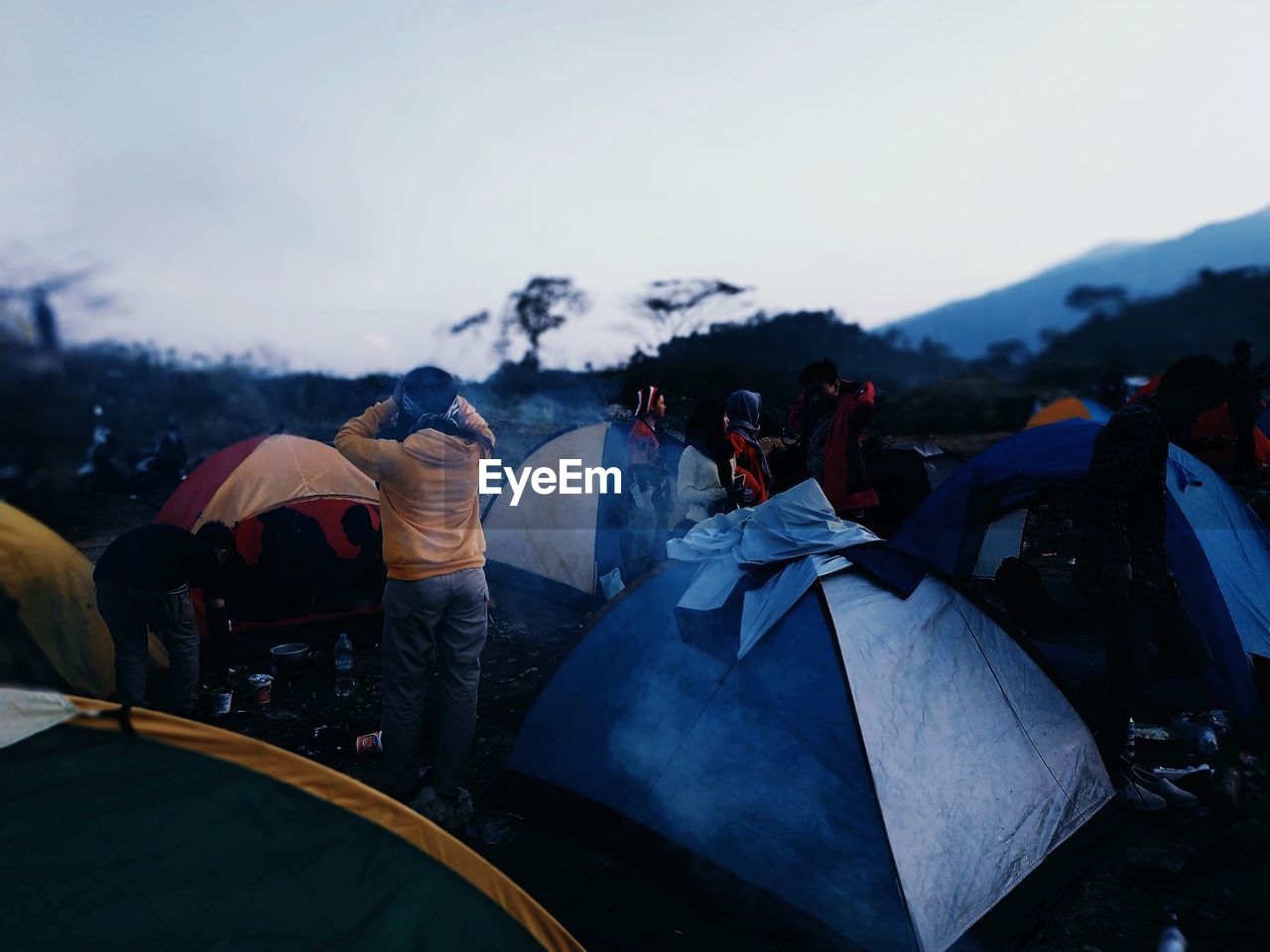 Group of people in tent against sky