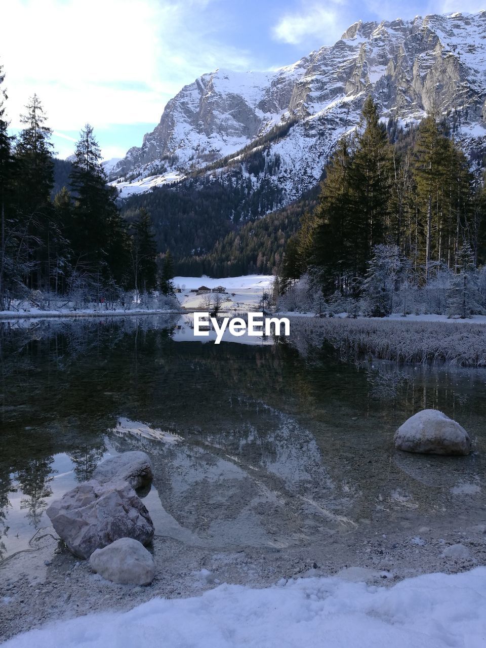 SCENIC VIEW OF FROZEN LAKE BY SNOWCAPPED MOUNTAINS