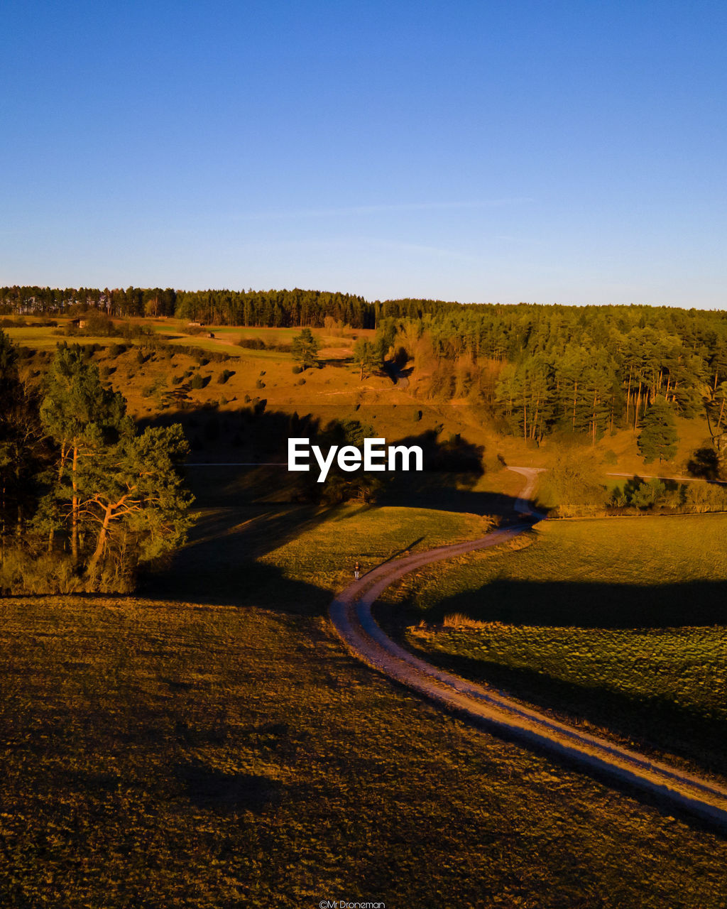 Scenic view of landscape against clear blue sky