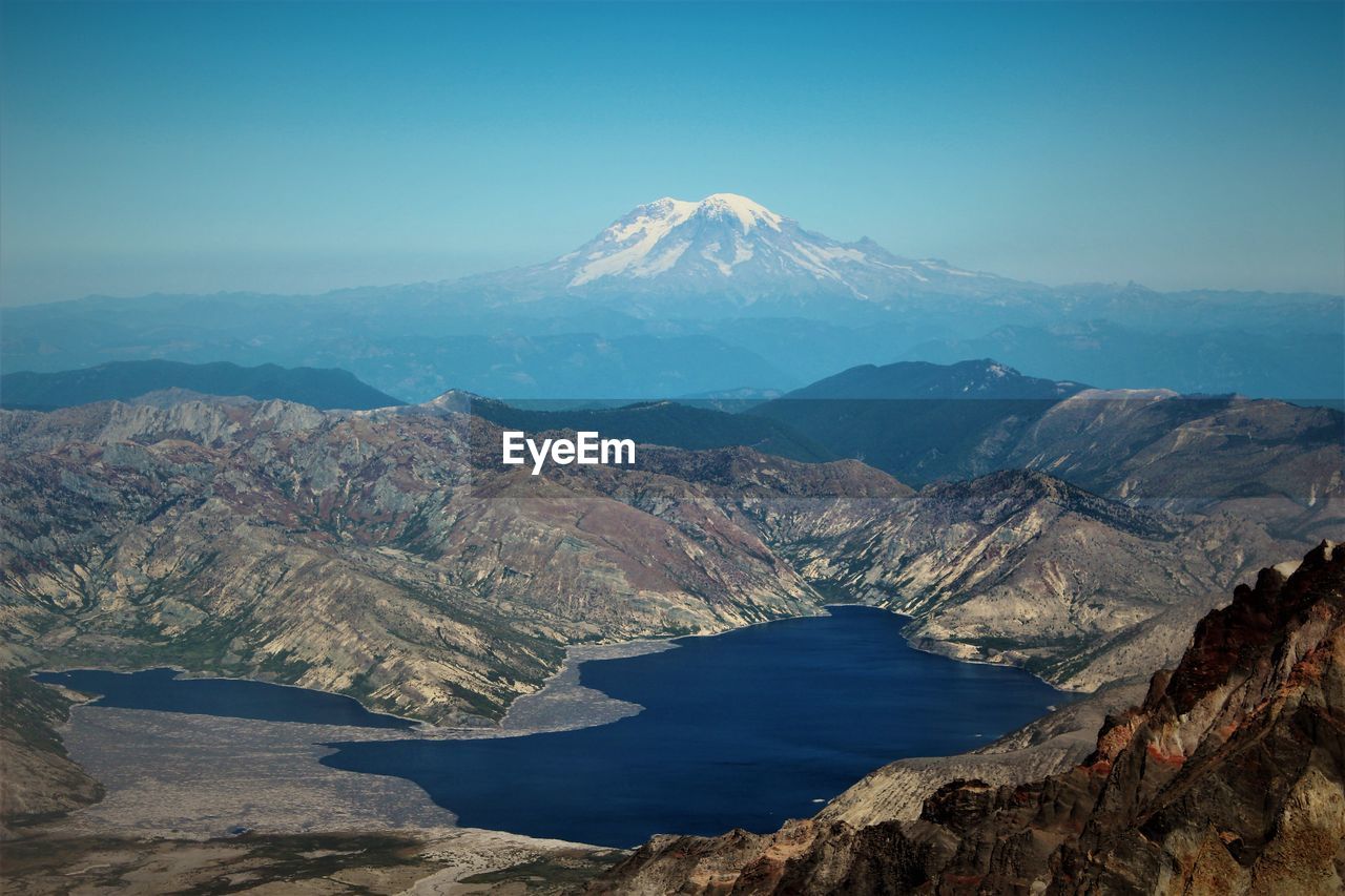 Scenic view of mountains against clear blue sky