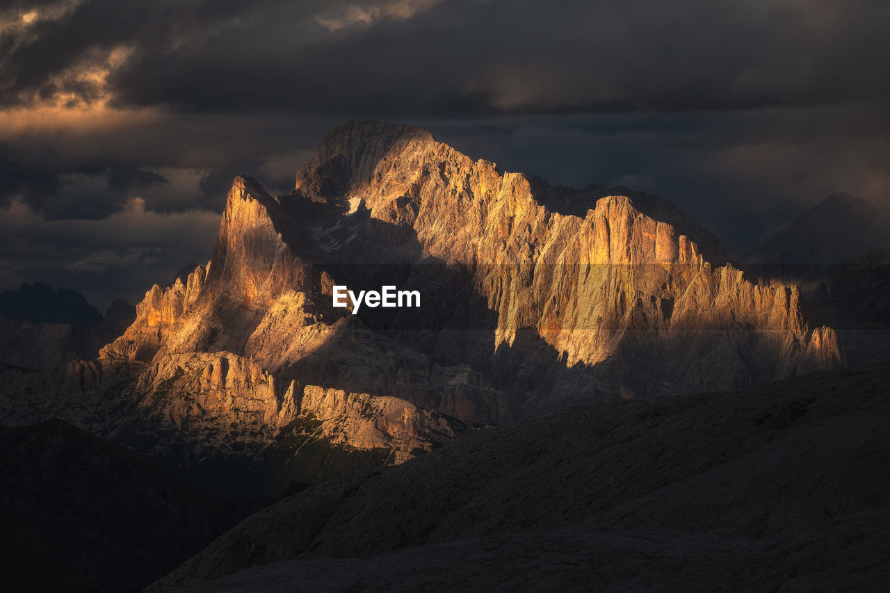 Moody landscape with dolomite mountains in perfect sunset light.