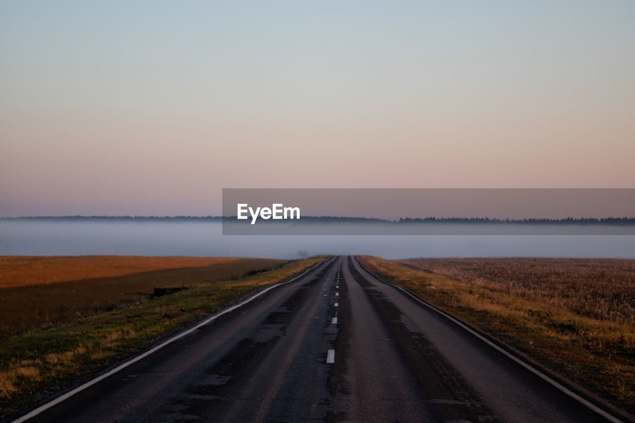 Road amidst landscape against sky during sunset