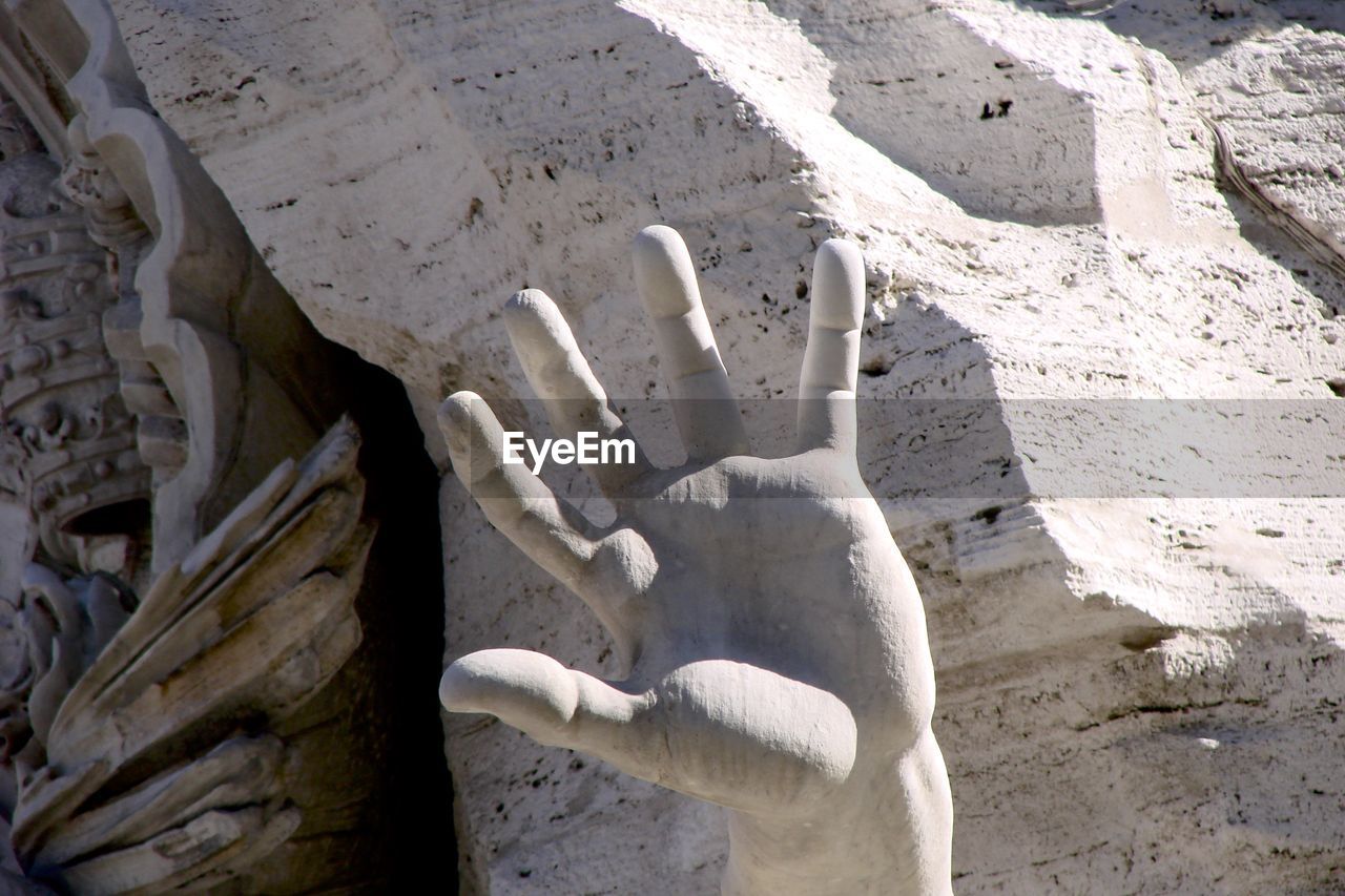 Cropped messy hand of person against rock formation