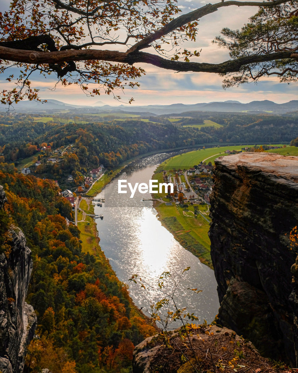 Scenic view of river amidst trees against sky during autumn