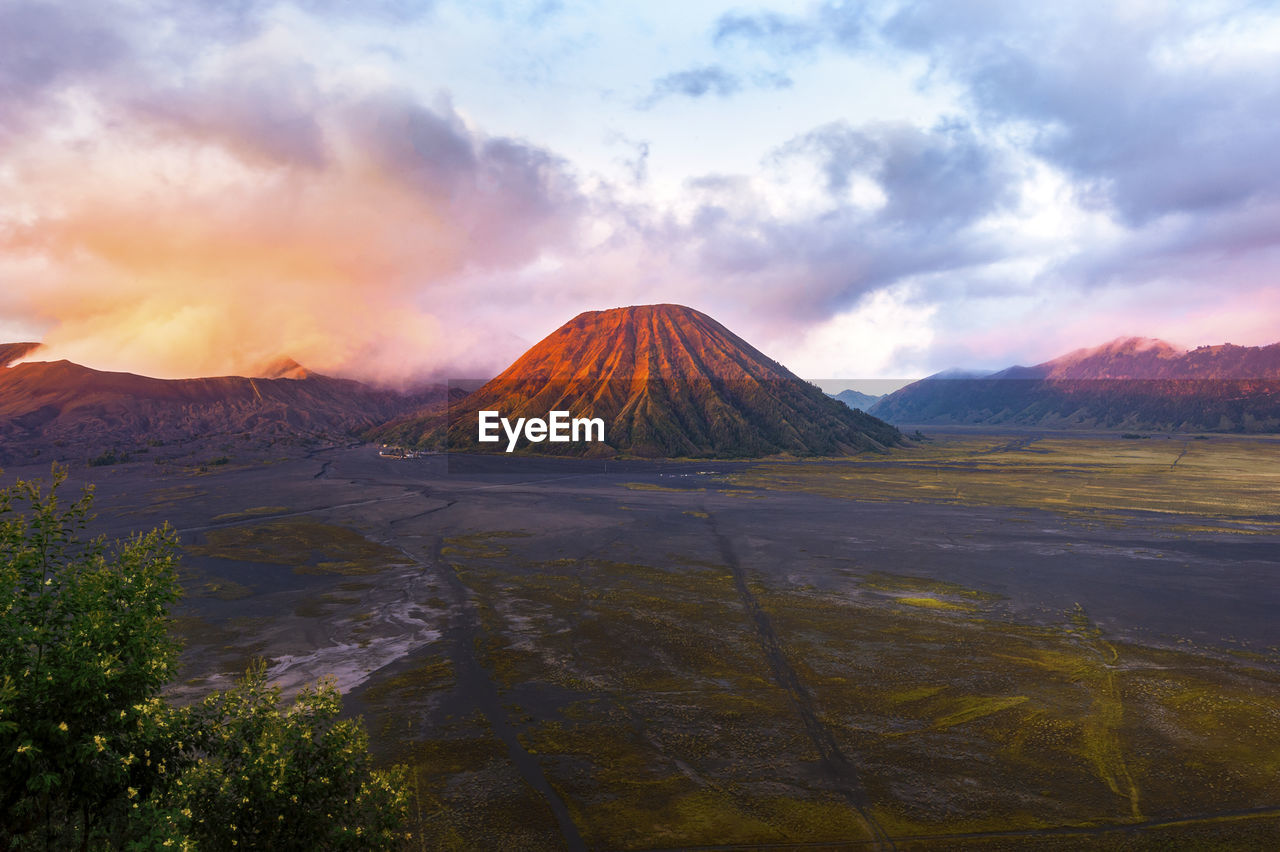 Scenic view of mountain against cloudy sky