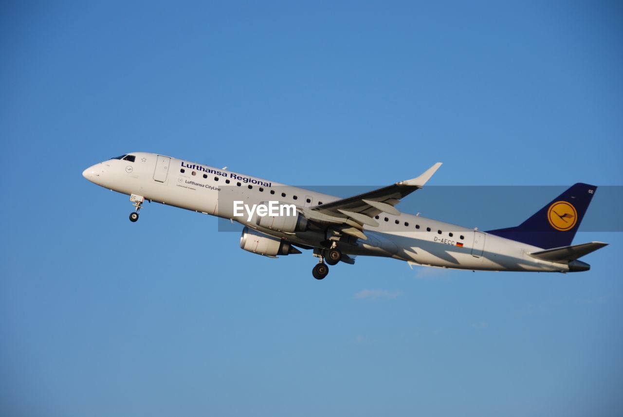 LOW ANGLE VIEW OF AIRPLANE FLYING IN SKY