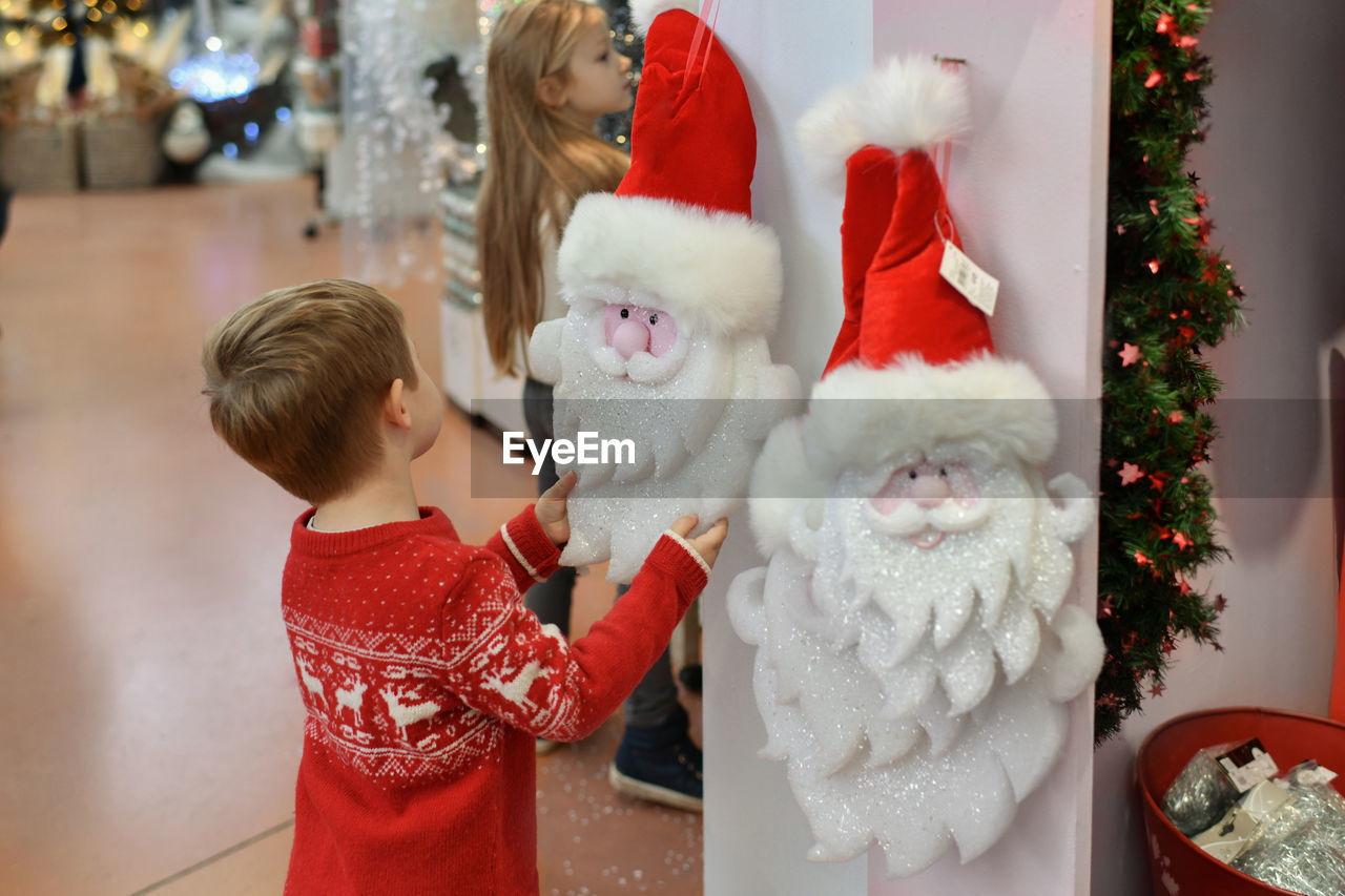 A kids choose the figurines for the christmas tree