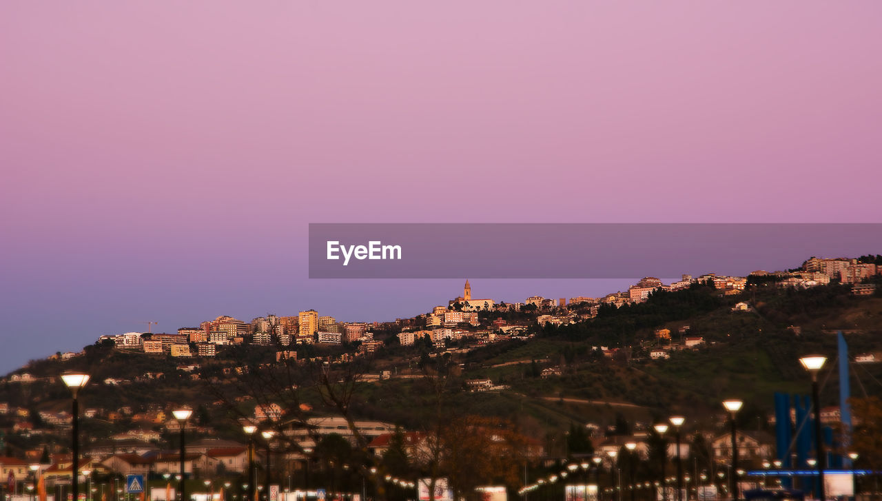 TOWN AGAINST SKY AT NIGHT