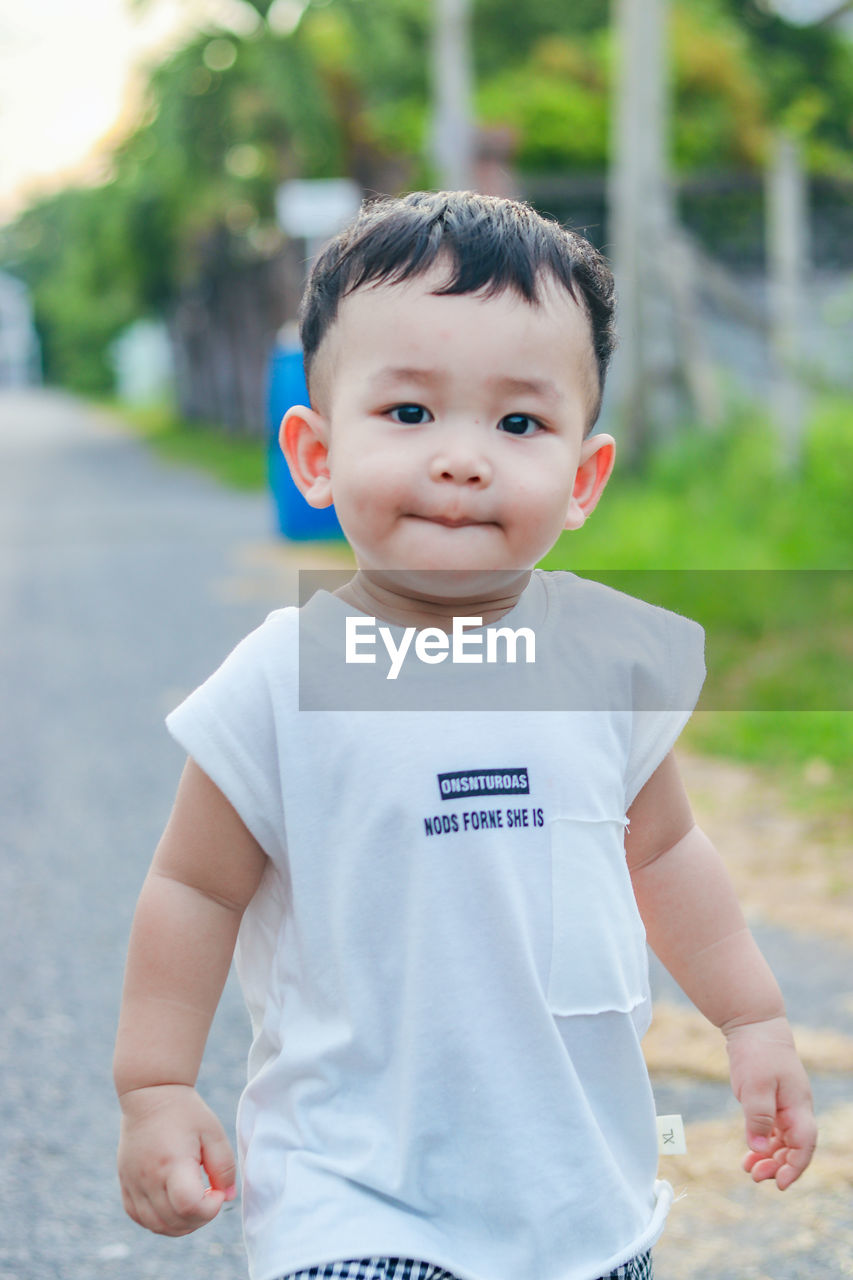 Portrait of cute boy standing outdoors