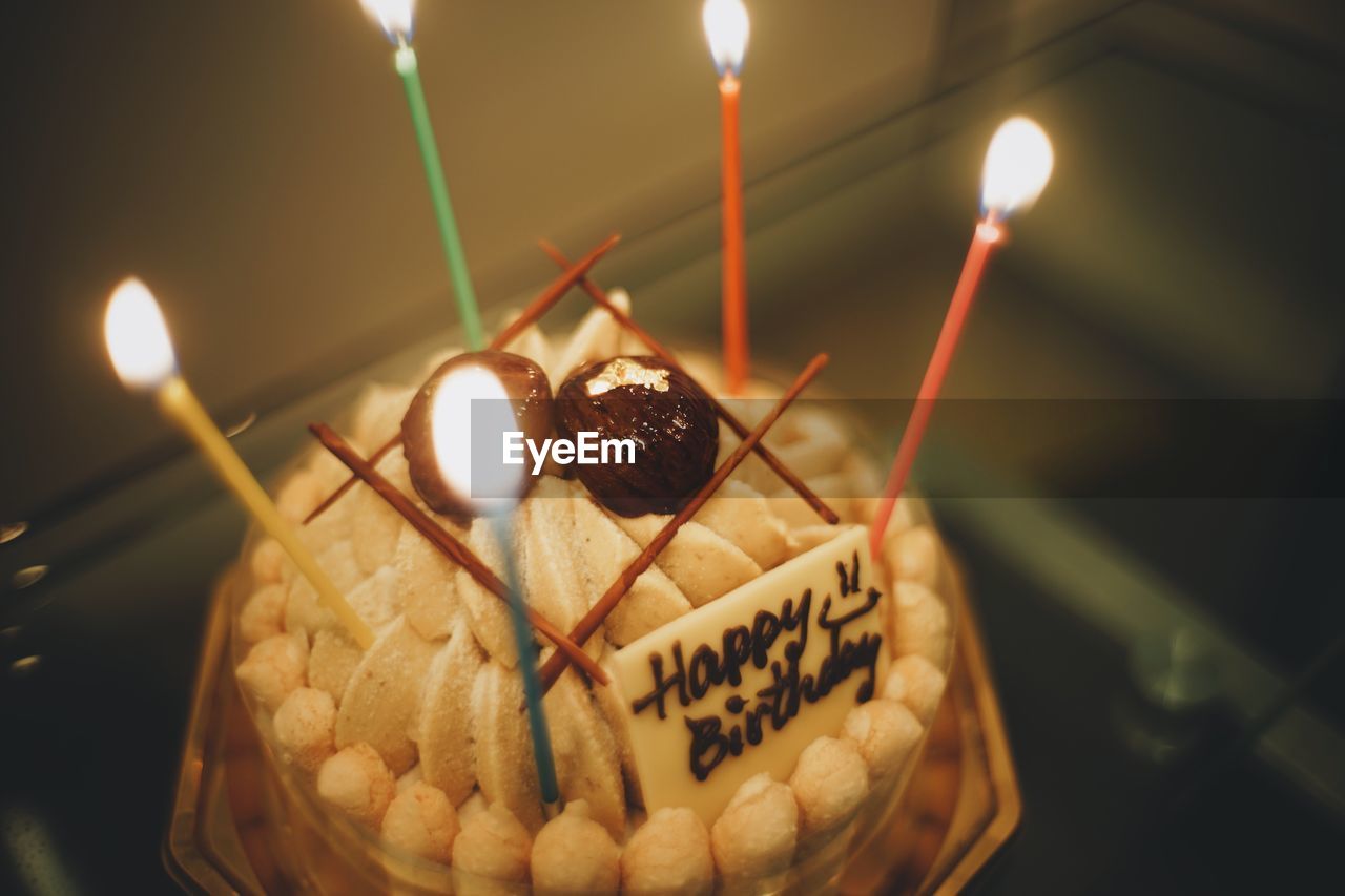 CLOSE-UP OF CAKE WITH CANDLES ON BIRTHDAY