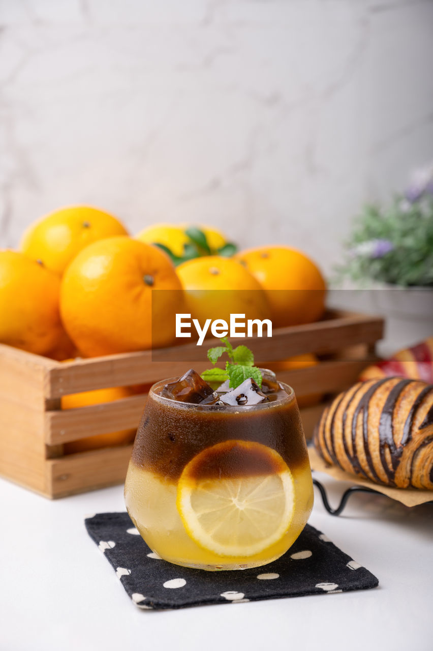 CLOSE-UP OF ORANGE FRUITS ON TABLE WITH YELLOW